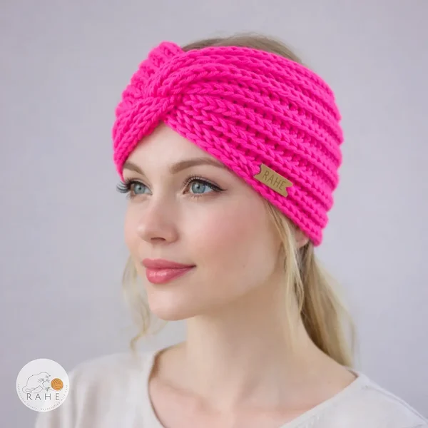 Hand-knitted wide merino wool headband worn by a female model, neon pink color, twisted design, soft and stretchy knit, RAHEcraft
