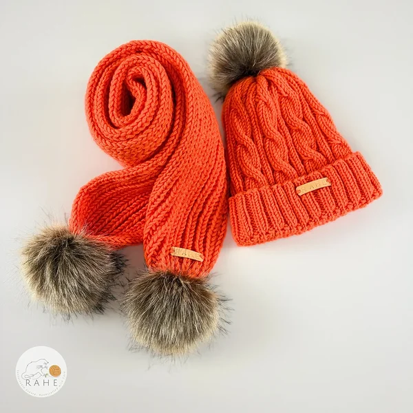 Orange hand-knitted merino wool children’s hat and matching scarf set with faux fur pom-poms by RAHEcraft