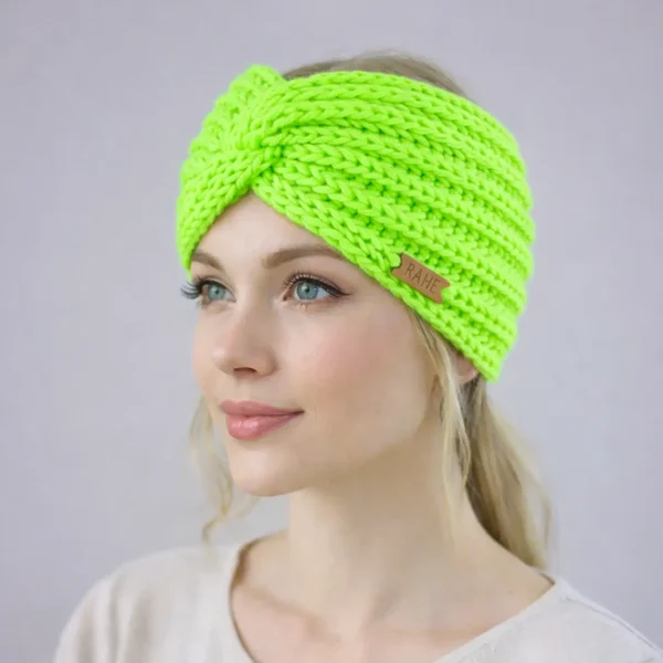 Woman wearing a hand-knitted neon green merino wool headband. Wide twisted knit ear warmer, handmade winter accessory by RAHEcraft.