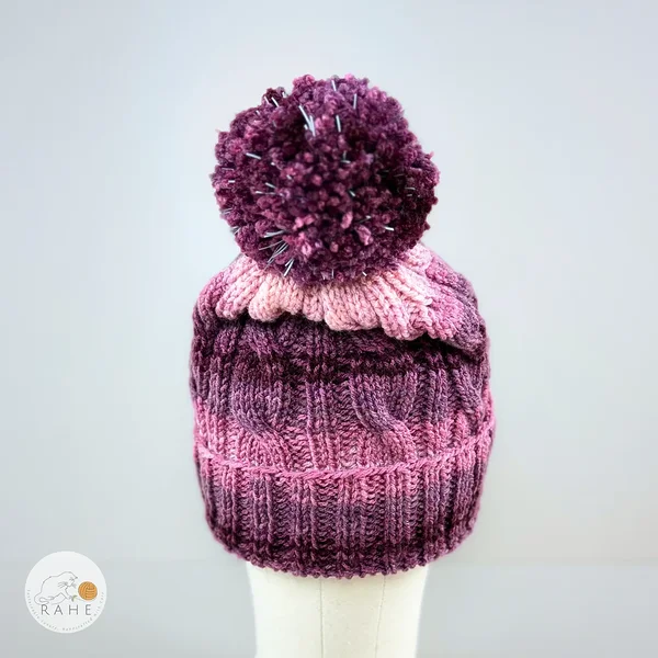 Artisan-crafted winter hat with a large pom-pom.