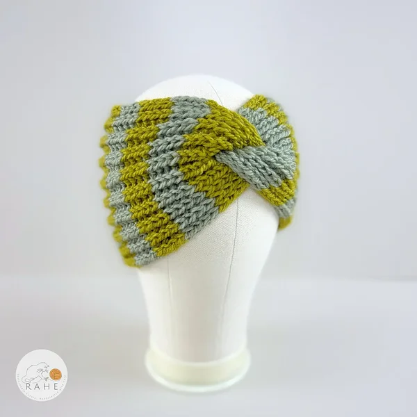 Angled view of a hand-knitted wool blend wide headband with sage and olive green stripes, RAHEcraft.