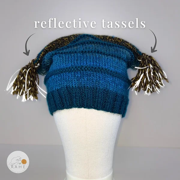 Reflective tassels improve visibility on a handmade knit hat for kids and adults