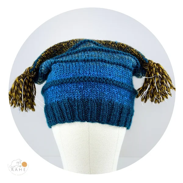 Front view of a hand-knitted reflective tassel hat designed for kids and adults