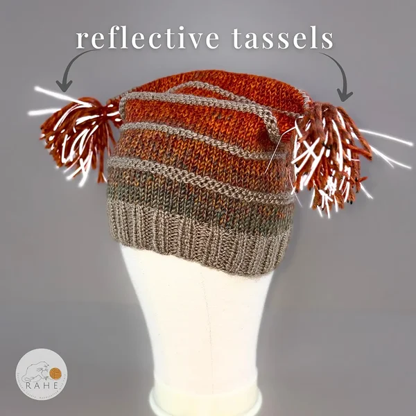 Reflective tassels detail on a hand-knitted wool blend winter hat