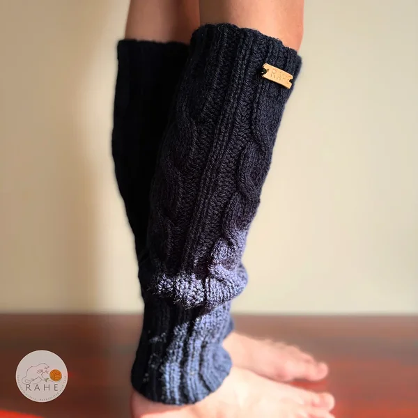 Side view of RAHEcraft hand-knitted cable knit leg warmers in soft navy blue yarn. Warm and stretchy spting accessory available in Teen and Kid sizes.