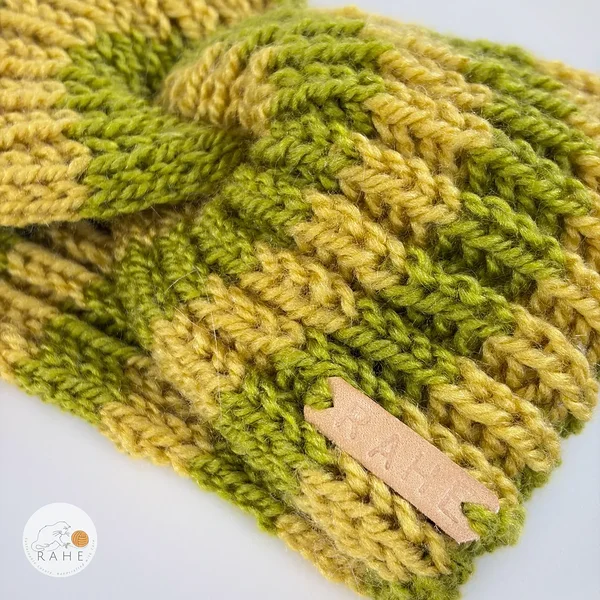 Hand-knitted wool blend headband for women in green and yellow tones, featuring a soft ribbed knit texture and a sewn RAHE label, detailed close-up view.