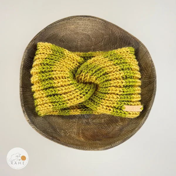 Hand-knitted wide wool blend headband flat lay with twisted center, yellow and green stripes, RAHEcraft