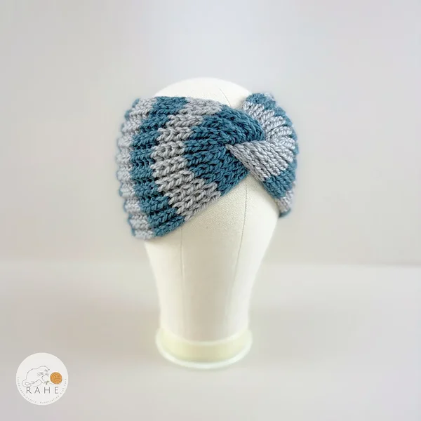 Angled view of a hand-knitted wool blend wide headband with grey and blue stripes, RAHEcraft.