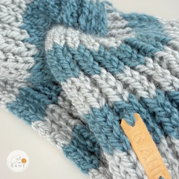 Hand-knitted wool blend headband for women in grey and blue tones, featuring a soft ribbed knit texture and a sewn RAHE label, detailed close-up view.
