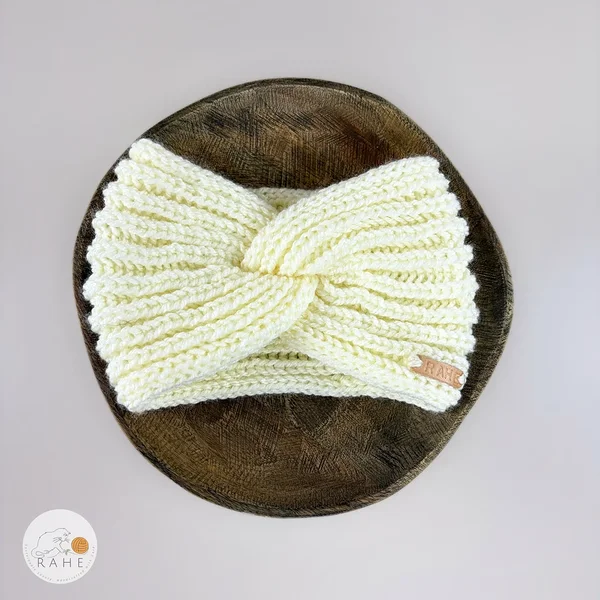Hand-knitted wide wool blend headband flat lay with twisted center, ivory white color, RAHEcraft