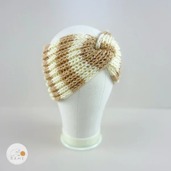 Angled view of a hand-knitted wool blend wide headband with beige and ivory white stripes, RAHEcraft.