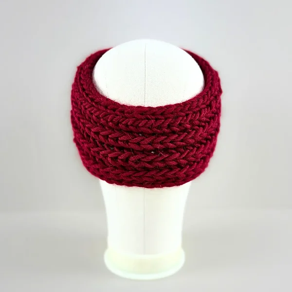 Back view of a hand-knitted red chunky wool ear warmers for girls and women.