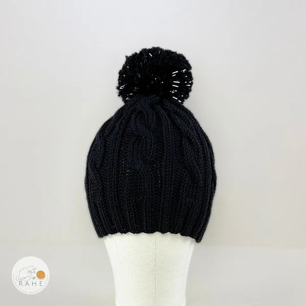 Hand-knitted black merino kids hat with a reflective bobble. Cable knit winter hat for girl and boys. Estonian handicraft.