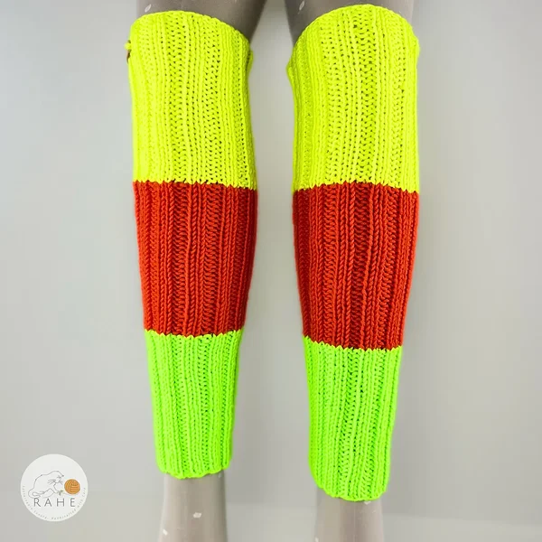RAHEcraft hand-knitted merino wool leg warmers in bright neon stripes. Stretchy rib-knit texture and premium handmade quality.
