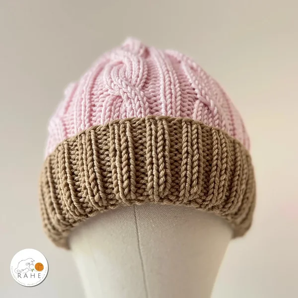 Womens pink winter hat in pink and beige. Hand-knitted wool winter hat for adults.
