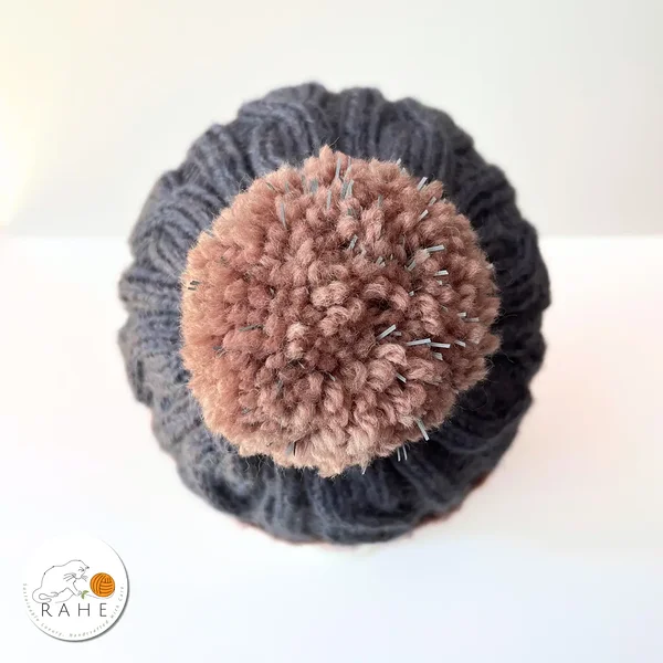 Top view of hand-knitted blue and beige wool beanie with reflective pom-pom – handmade reflective  winter hat suitabe for kids, teens, women, and men.