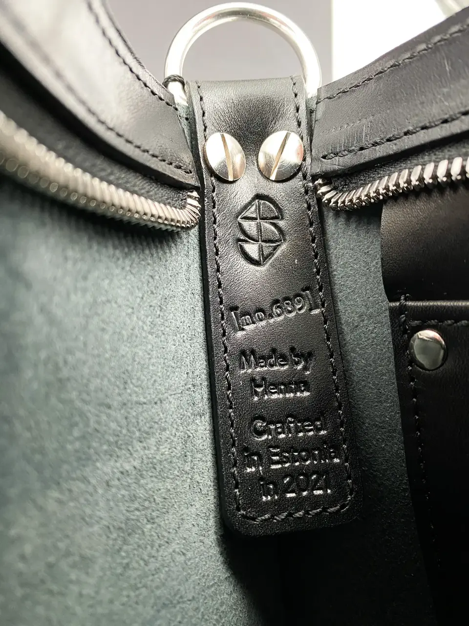 The leather label inside a Stella Soomlais bag — number, crafter's name and Crafted in Estonia