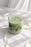 Green candle in soft sunlight